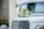 Phillip Hall wedding photo of wedding flowers on the hood of an vintage car