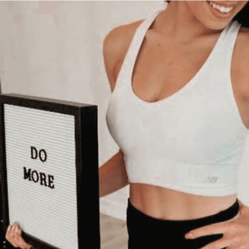 Woman performing a dumbbell strength training exercise