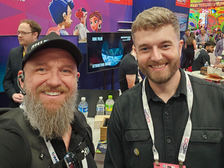 RH1 CEO Claude Rety with partners and suppliers at IAAPA Expo 2025, discussing innovation and industry trends