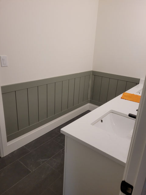 Custom wainscoting and bench seat with beadboard paneling in hallway