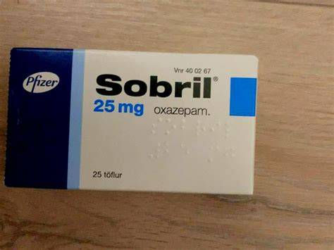 Pfizer Sobril 25 mg oxazepam box on a wooden table, with blue and white packaging and visible product text.