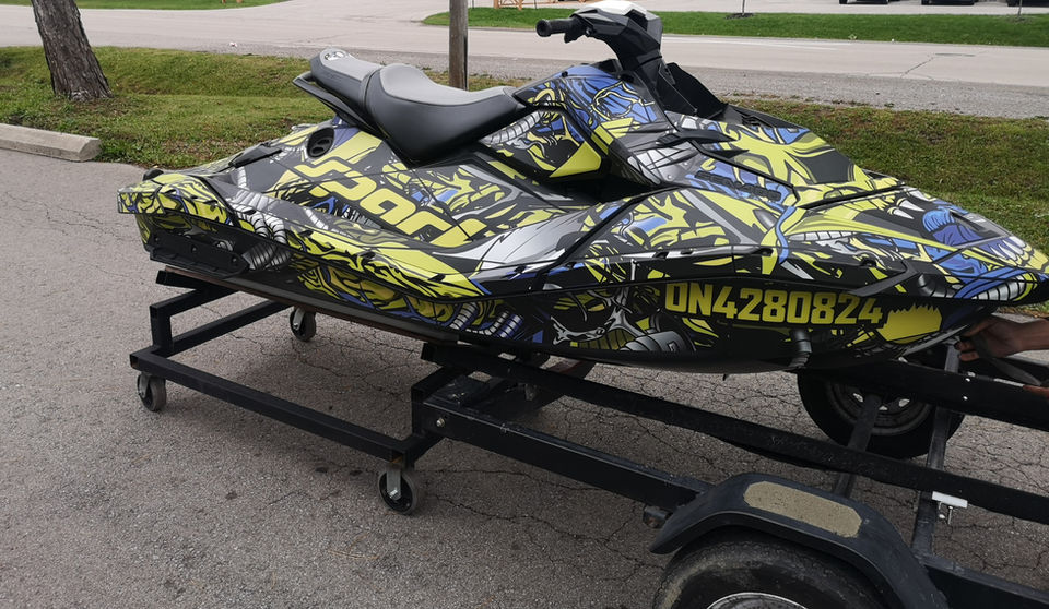 Complete Sea Doo covered in stickers.