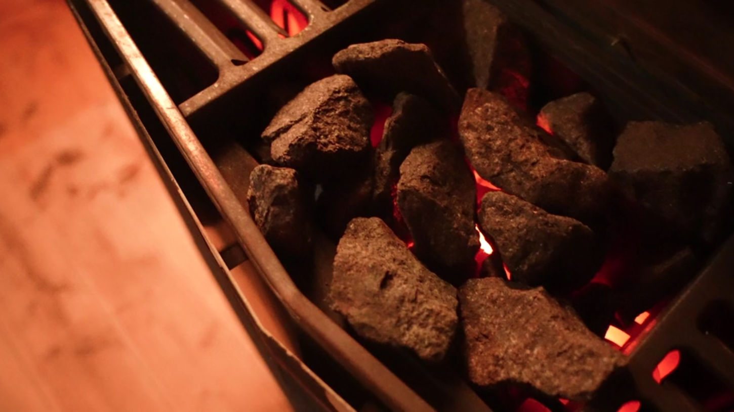 A close up of the hot sauna rocks inside of the Trevarefabrikken sauna in Lofoten, Norway.