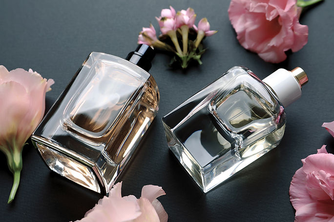 bottles-perfume-with-flowers-dark-background.jpg