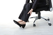 Business woman having pain on foot.jpg