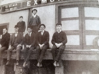 Merchants sit on the railroad platform wating for the train.