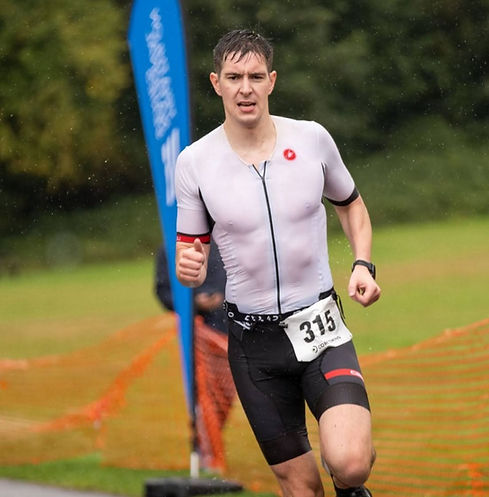 Triathlete grimacing in the rain