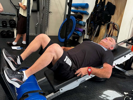 Man using a gym machine to do squats