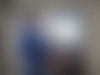 Maintenance technician using a wall mounted screen in an organized MRO storeroom to browse a supplier PunchOut catalog with parts, pricing, and add to cart options