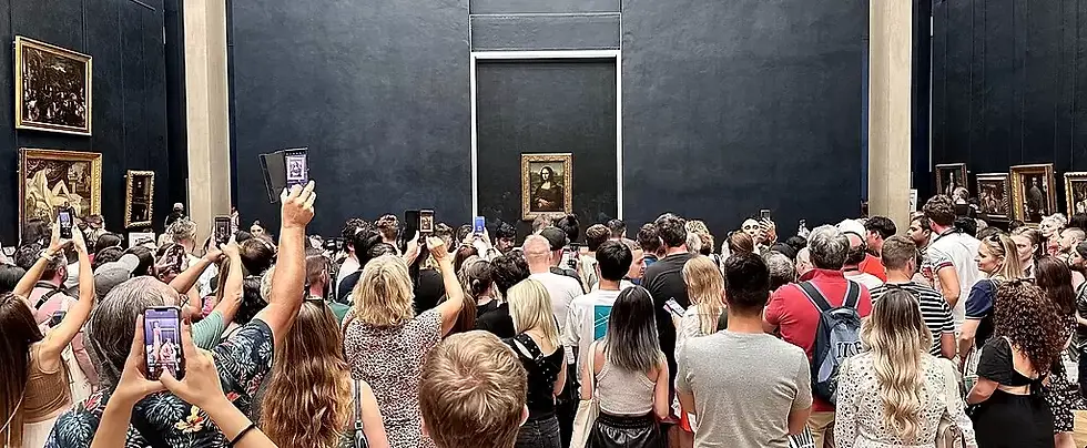 The art hype: a crowd of visitors taking photos at the Louvre Museum