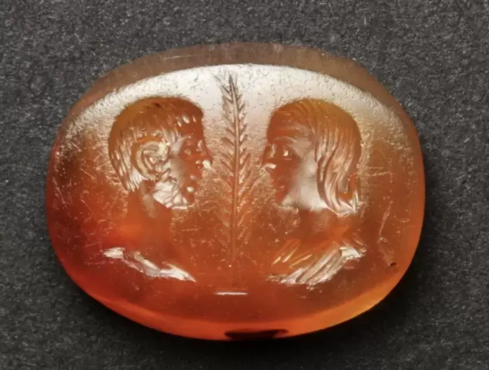 Ancient Roman intaglio depicting a male and female bust separated by a palm leaf; possibly a marriage intaglio