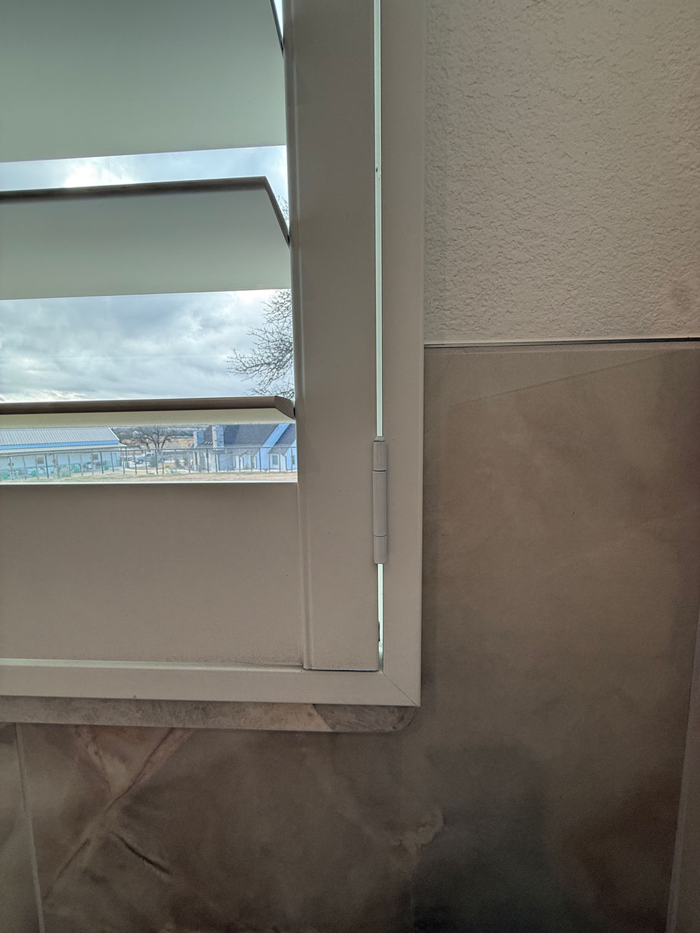 White louvered window shutters