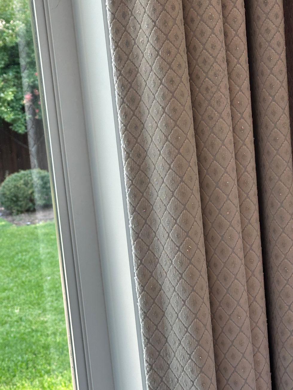 Patterned custom drapery by a window with a view