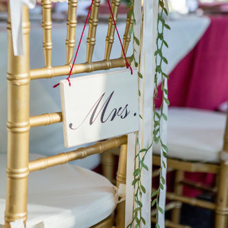Gold chair with 'Mrs.' sign, wedding decor