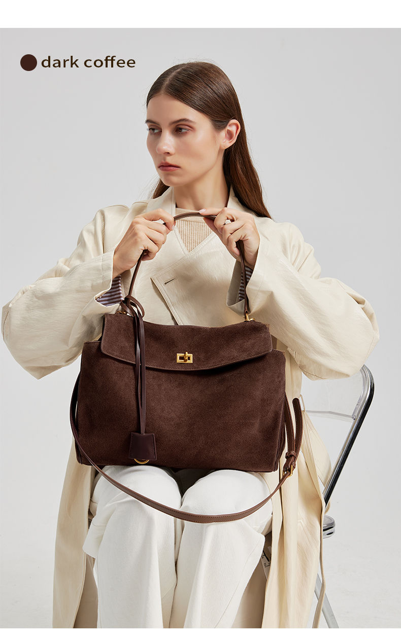 Thumbnail: Dark Brown Heritage Suede Leather Tote Bag – Premium Edition carried by the model.