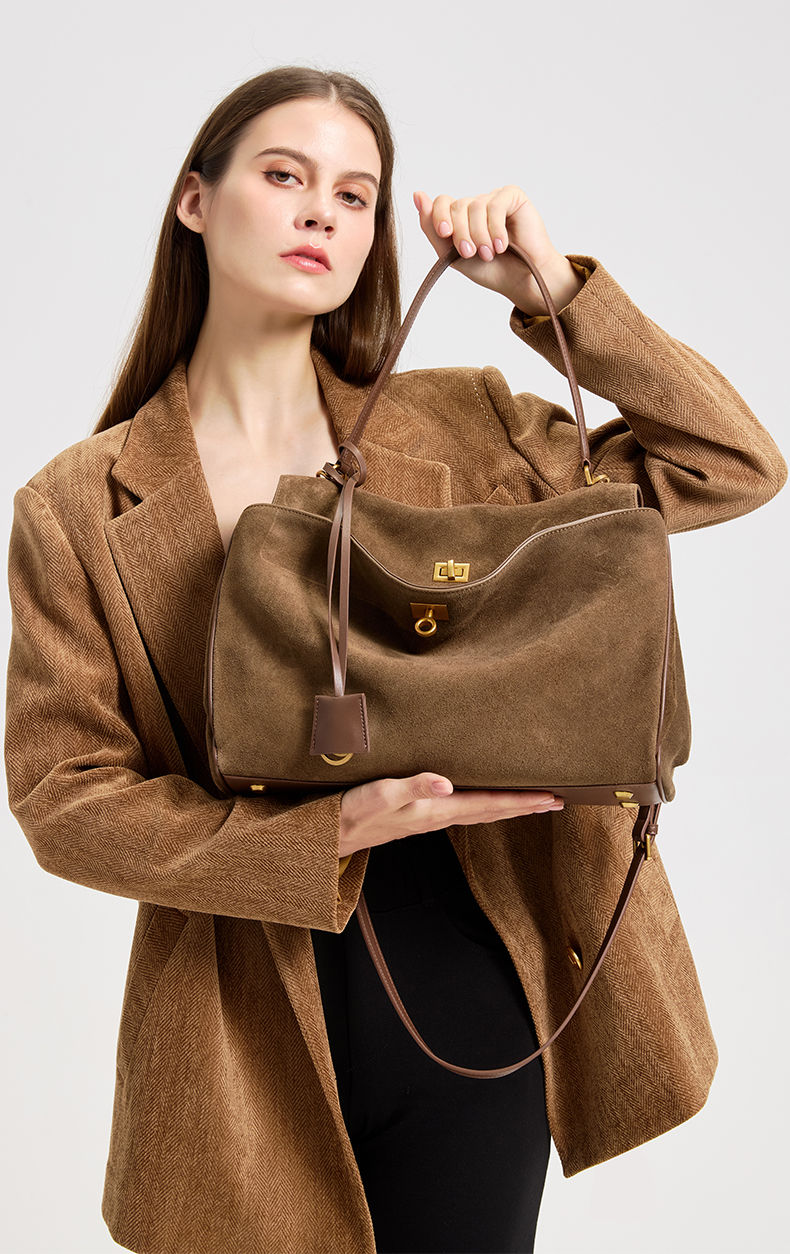 Thumbnail: Chocolate Brown Heritage Suede Leather Tote Bag – Premium Edition carried by the model.