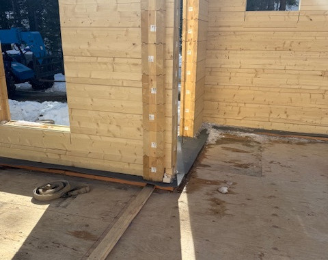 The construction and interaction of the Mass Log Wall system at corners and openings.