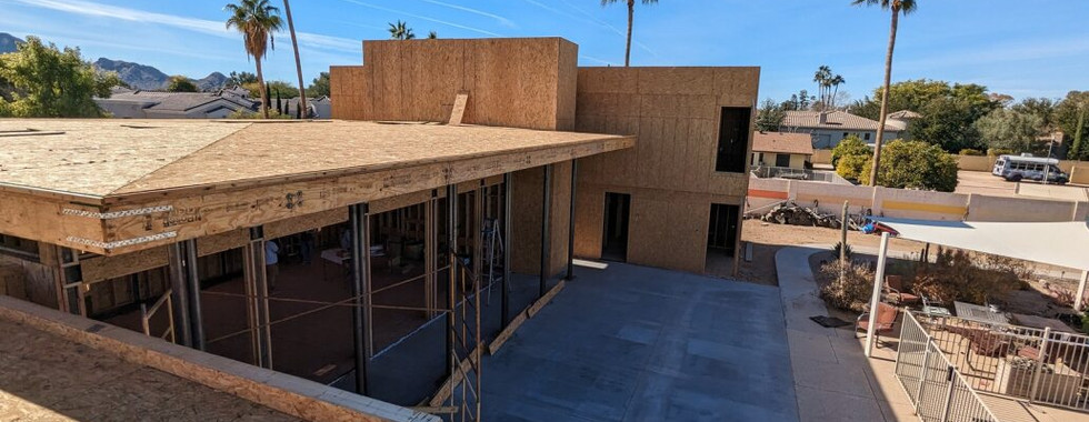 View from roof showing construction progress with palm trees in background
