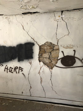 Photo of parking garage with cracked wall