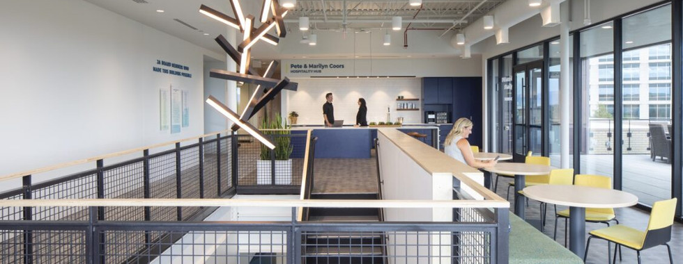 Upstairs level of building with open workspaces and staircases 