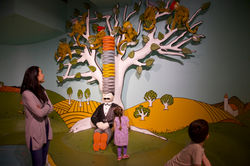 Mom and children look at exhibit