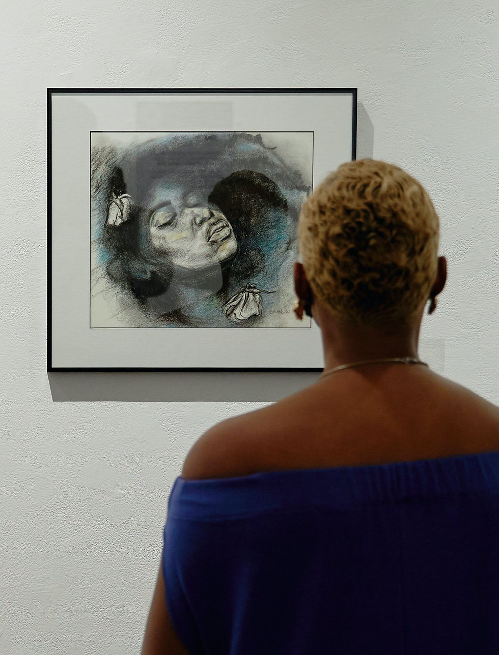 Visitor viewing artwork at the Multicultural Arts Center