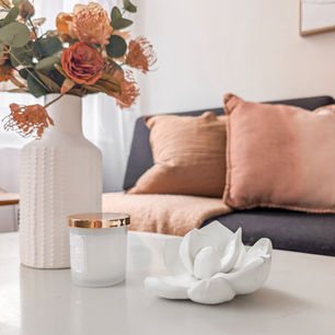 Open-plan kitchen and living room staging with dark wood cabinets, sculptural ottoman and warm neutrals London by House of ONO.