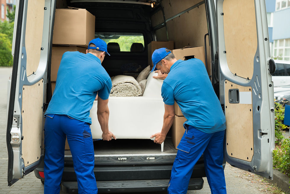 Removal men in blue packing a truck