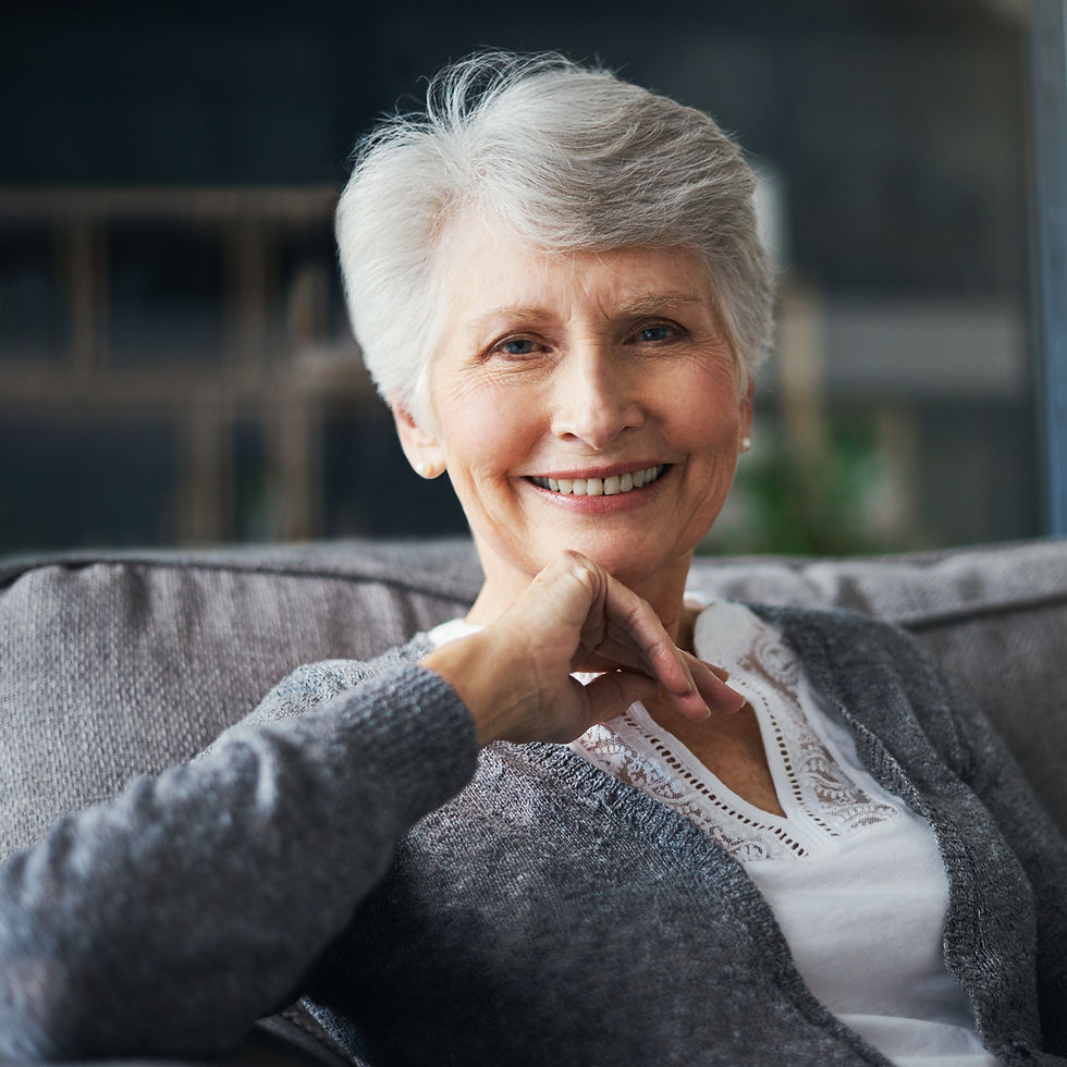 Satisfied patient showing off beautiful smile after implant restoration