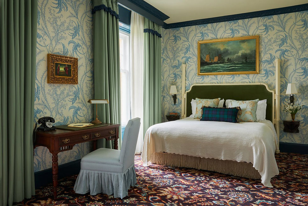 A luxurious hotel bedroom featuring bed and curtains.