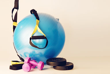 pilates ball with dumbbells and trx strings on white background and floor.jpg