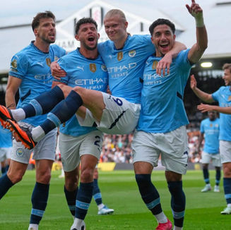 Manchester City players celebrating a goal.