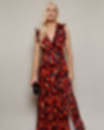 Vivid red and orange floral print on deep navy wrap dress – striking painterly blooms for evening and occasion wear.