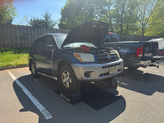 Redline Mobile Automotive Service technician performing an on-site oil change in New Jersey.