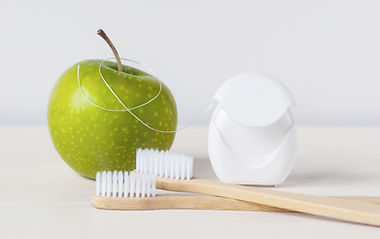 bamboo-toothbrushes-green-apple-dental-floss-white-background-dental-care-routine-keep-hea