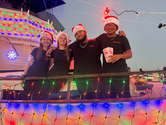 Zero Turbulence posing on the illuminated boat Izzy Rose bfore the Perry Hotel Lighted Boat Parade in Key West.