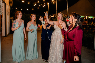 bride celebrating with bridesmaids at reception