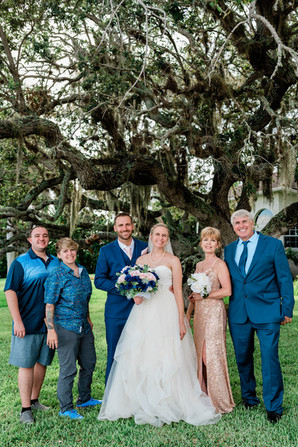 bride and groom pose with brides family
