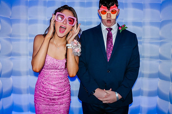 couple poses with props in LED Inflatable photo booth