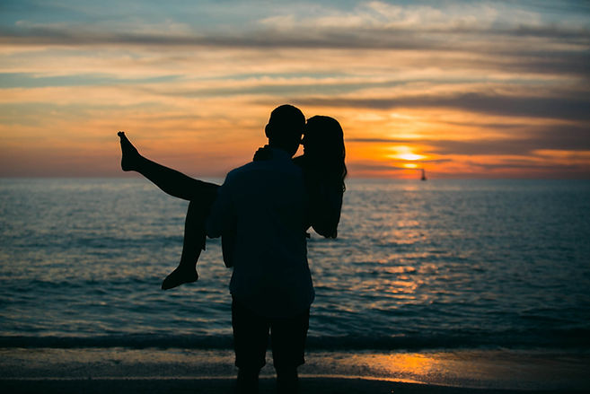 steamy couple's engagement sunset photo session at North Jetty Beach in Nokomis, FL
