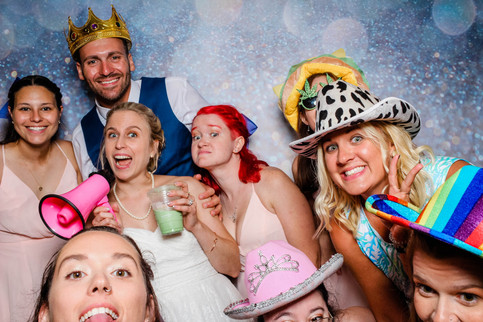 wedding guest having a great time in the photo booth