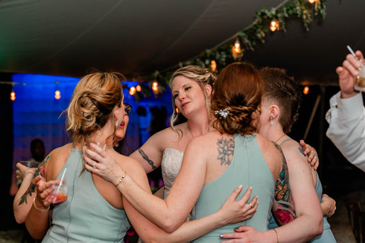 bride and bridesmaids celebrate on dancefloor at chapel creek wedding and events