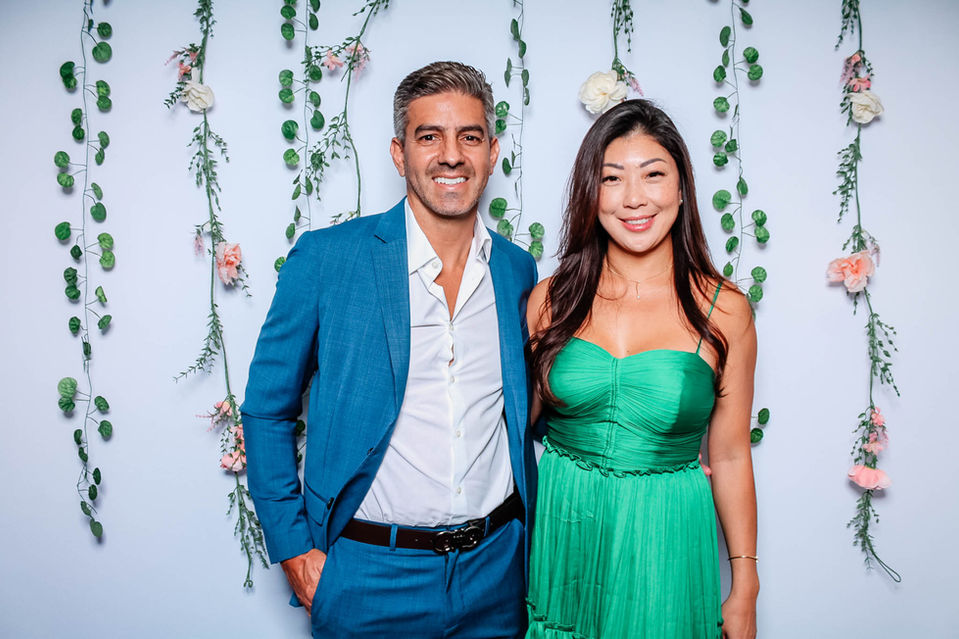 Smiling couple at floral backdrop