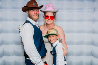 bride and groom pose in photo booth at chapel creek wedding and events