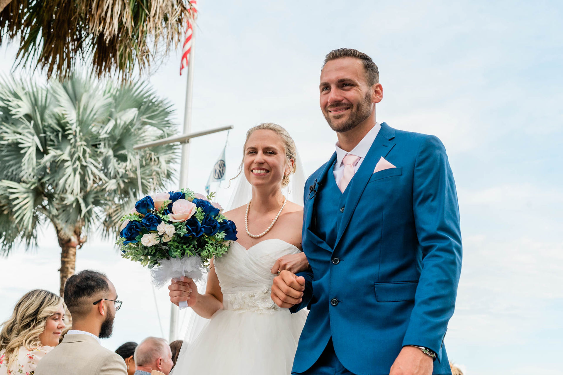 bride and groom walking out of ceremony happily married