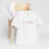Thumbnail: White Supertramp t-shirt displayed on chair with multicolor logo.