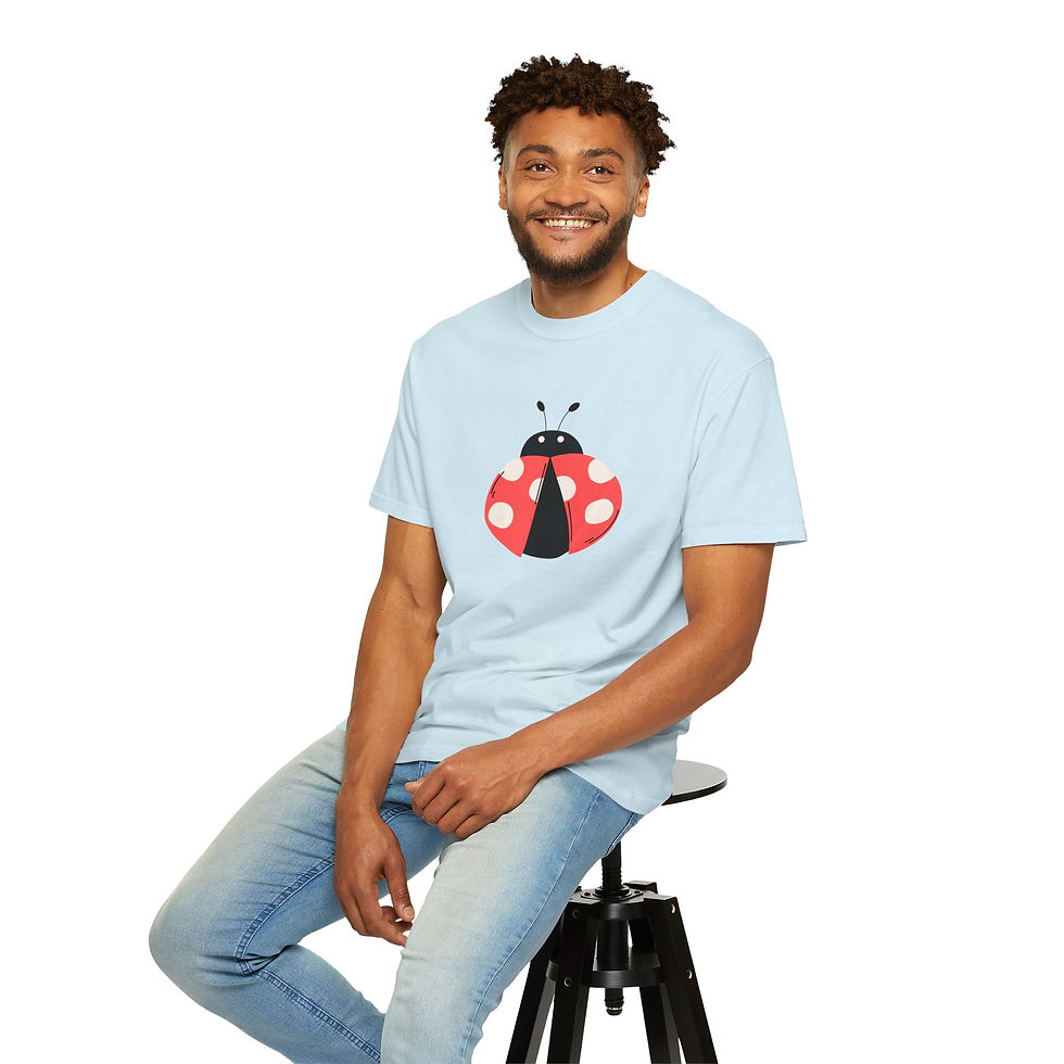 Man wearing a light blue Lady Bug T-Shirt while sitting on a stool.
