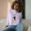 Thumbnail: Woman wearing lavender E.T. crop hoodie sitting on the floor