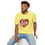 Thumbnail: Man sitting and smiling in a yellow “I Love Lucy” T-shirt and jeans.