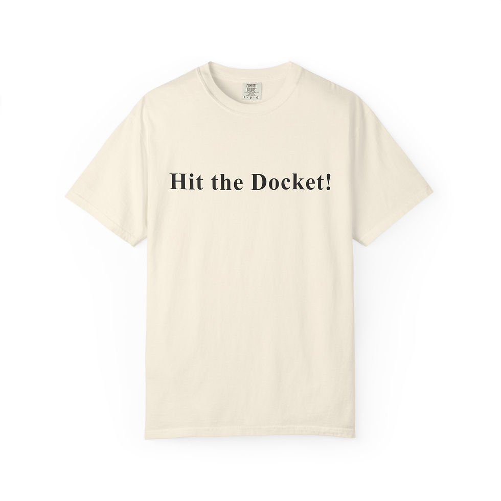 Flat cream colored tee on a white background showing the text “Hit the Docket!” centered on the chest